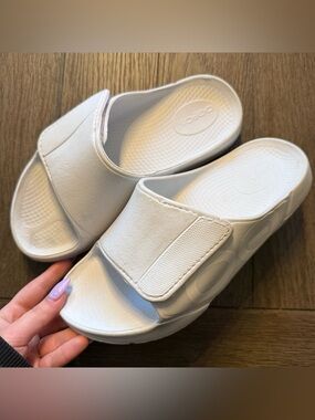 White oofos slides